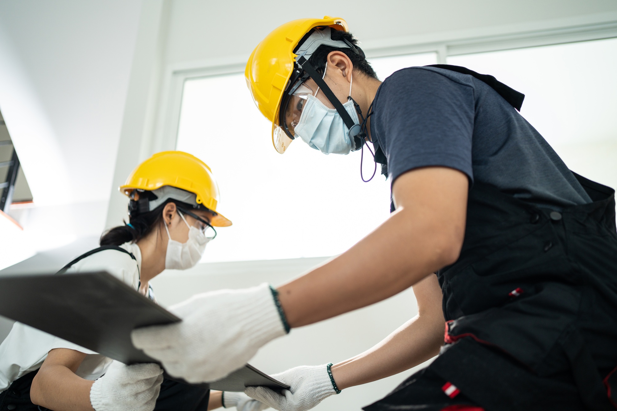 Asian Craftsman builder installs laminate board on floor to renovating house due to Covid